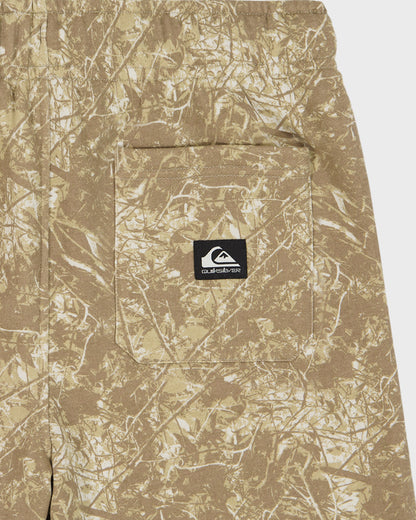 Camouflage-patterned pants with a brand logo on a white background