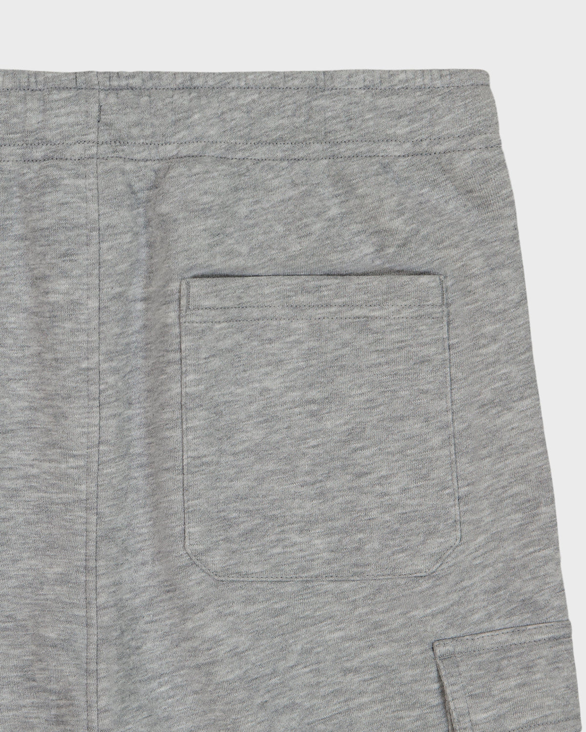 Close-up of black pants with a button on a white background