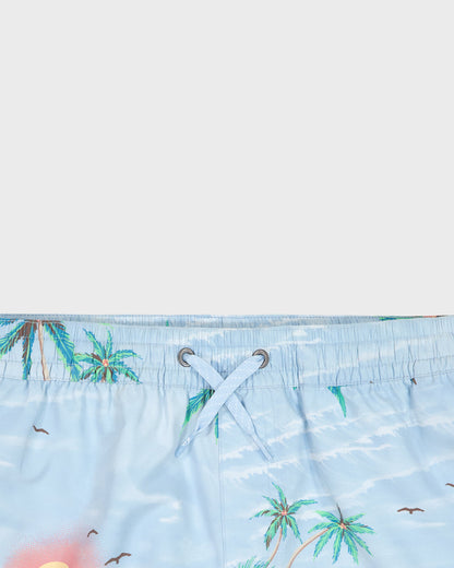 Close-up of a blue swimsuit with palm tree pattern on a white background